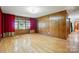 Spacious bedroom with hardwood floors, paneled walls, and large windows at 3135 Lake Shore S Rd, Denver, NC 28037