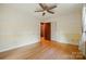 Bright bedroom featuring laminate floors, a ceiling fan, and closet at 3135 Lake Shore S Rd, Denver, NC 28037