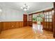 Bright dining room with hardwood floors, paneled walls, and a sliding barn door at 3135 Lake Shore S Rd, Denver, NC 28037