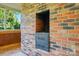 Close up of a brick fireplace with a built-in grill at 3135 Lake Shore S Rd, Denver, NC 28037