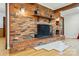 Exposed brick fireplace with wood beams, hardwood floors, and custom lighting at 3135 Lake Shore S Rd, Denver, NC 28037