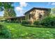 Charming single-story home with a lush green lawn, mature trees, and manicured landscaping at 3135 Lake Shore S Rd, Denver, NC 28037