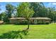 Charming single-story home with a well-manicured lawn, lush greenery, and a welcoming entrance at 3135 Lake Shore S Rd, Denver, NC 28037