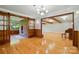 Spacious living room with hardwood floors, exposed beams, and a brick fireplace at 3135 Lake Shore S Rd, Denver, NC 28037