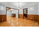 Large living room with hardwood floors, paneled walls, and ample lighting at 3135 Lake Shore S Rd, Denver, NC 28037