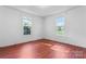 Sunlit bedroom features red-wood floors and bright white walls, providing a cozy atmosphere at 317 Campus St, Charlotte, NC 28216