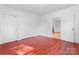 Clean bedroom with red wood flooring, white walls, and plenty of natural light at 317 Campus St, Charlotte, NC 28216