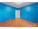 Spacious bedroom with unique blue walls and laminate flooring, creating a calming ambiance at 317 Campus St, Charlotte, NC 28216