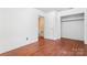 Bedroom with hardwood floors, closet, and door to hallway at 317 Campus St, Charlotte, NC 28216