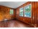 Bedroom featuring hardwood floors and wood paneled walls at 317 Campus St, Charlotte, NC 28216
