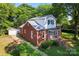 Traditional home with detached garage, mature trees, and well-maintained landscaping at 317 Campus St, Charlotte, NC 28216