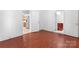 Clean, spacious hallway featuring laminate wood flooring and doors to the kitchen and bathroom at 317 Campus St, Charlotte, NC 28216