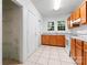 Functional kitchen with white appliances, wood cabinets, and convenient storage area at 317 Campus St, Charlotte, NC 28216