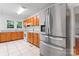 Spacious kitchen featuring stainless steel refrigerator, white appliances, and wood cabinets at 317 Campus St, Charlotte, NC 28216