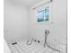 Clean laundry room with tiled floors, hookups for the machines, and a window at 317 Campus St, Charlotte, NC 28216