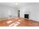 Bright living room boasts a fireplace and neutral walls with hardwood flooring at 317 Campus St, Charlotte, NC 28216