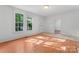 Light-filled living room with large windows and a combination of tile and wood flooring at 317 Campus St, Charlotte, NC 28216