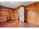 Study featuring wood paneling, built-in desk and shelves and hardwood floors at 317 Campus St, Charlotte, NC 28216
