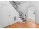 Traditional stairway with hardwood steps and a wrought iron railing and a door to the basement at 317 Campus St, Charlotte, NC 28216