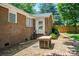 Back door, brick patio, and exterior brick detail on a sunny day at 318 W Peeler St, Salisbury, NC 28146