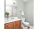 Powder room with a sink, vanity, and a toilet complemented by blue flower arrangement at 318 W Peeler St, Salisbury, NC 28146