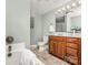 Well-lit bathroom with a tub, toilet, vanity, and neutral-toned walls at 318 W Peeler St, Salisbury, NC 28146