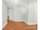 Well-lit empty bedroom with hardwood floors and neutral walls at 318 W Peeler St, Salisbury, NC 28146