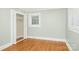 Bright bedroom with hardwood floors, a window, and closet with bi-fold doors at 318 W Peeler St, Salisbury, NC 28146