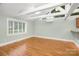A bedroom with hardwood flooring, vaulted ceilings and natural light from a large window at 318 W Peeler St, Salisbury, NC 28146