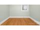 This room has hardwood flooring, neutral walls, and a window for natural light at 318 W Peeler St, Salisbury, NC 28146