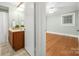 Bright bedroom with wood floors connected to a bathroom featuring a vanity and shower at 318 W Peeler St, Salisbury, NC 28146