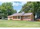 Ranch style home with a stone facade, manicured lawn, and covered front porch with columns at 318 W Peeler St, Salisbury, NC 28146