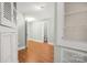 Inviting hallway featuring hardwood floors, storage, and a view of a bathroom at 318 W Peeler St, Salisbury, NC 28146