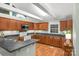 Well-lit kitchen with stainless steel appliances, laminate countertops, and wood cabinets at 318 W Peeler St, Salisbury, NC 28146