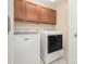Bright laundry room featuring a modern washer and dryer, with built-in cabinetry above at 318 W Peeler St, Salisbury, NC 28146