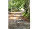 Gravel driveway lined with mature trees provides a private entrance to this home in a wooded setting at 3910 Winter Rd, Rock Hill, SC 29730