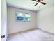 Simple bedroom with carpet and neutral walls with a window providing natural light at 4004 Stillwater Ct, York, SC 29745
