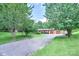 Landscaped front yard with a long driveway leading to a brick home at 4004 Stillwater Ct, York, SC 29745
