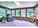Inviting sunroom with wood paneling, multiple windows, and comfortable seating, perfect for relaxation and enjoying nature at 4004 Stillwater Ct, York, SC 29745