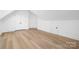 Bright bedroom with white trim, wood-look flooring, and multiple doors at 4032 Brandy Creek Ct, Clover, SC 29710