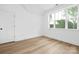 Well-lit bedroom with wood-look flooring and large windows overlooking the outdoor landscape at 4032 Brandy Creek Ct, Clover, SC 29710