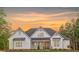 Stunning two-story home with white siding and a beautifully landscaped front yard at sunset at 4032 Brandy Creek Ct, Clover, SC 29710