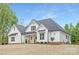 Beautiful two-story home with white siding, a dark roof, and a landscaped front yard at 4032 Brandy Creek Ct, Clover, SC 29710