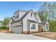 Exterior elevation of a modern farmhouse with a three-car garage and front garden at 4032 Brandy Creek Ct, Clover, SC 29710