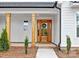 Inviting front entrance with a wooden door, decorative wreath, and natural wood support columns at 4032 Brandy Creek Ct, Clover, SC 29710