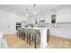 Modern kitchen with white cabinets, large island with seating, and stainless steel appliances at 4032 Brandy Creek Ct, Clover, SC 29710