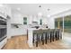 Bright kitchen features white cabinets, an island with seating, and stainless appliances at 4032 Brandy Creek Ct, Clover, SC 29710