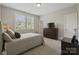 Bedroom features a comfortable bed, dresser, and natural light from the window at 426 Kirkbride Ct, Fort Mill, SC 29715