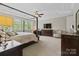 Airy bedroom featuring large windows, a four-poster bed, and neutral decor for a cozy and inviting space at 426 Kirkbride Ct, Fort Mill, SC 29715