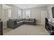 Comfortable bonus room features a large sectional sofa, natural light, and entertainment center at 426 Kirkbride Ct, Fort Mill, SC 29715
